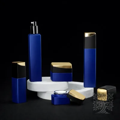 Emergence collection in vivid royal blue, featuring sleek bottles and jars with black caps on white platforms.
