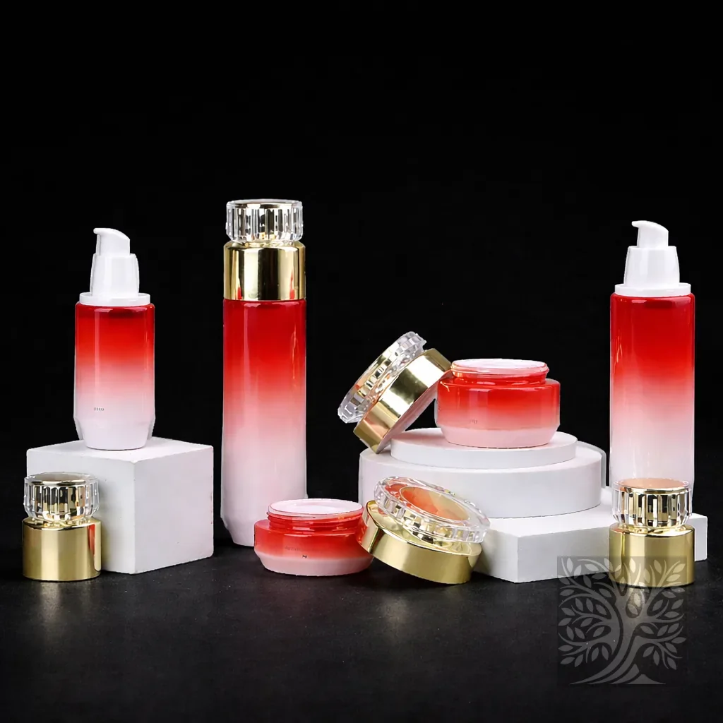 Red to white gradient glass skincare bottles and jars with gold caps, arranged with layered pedestal styling.