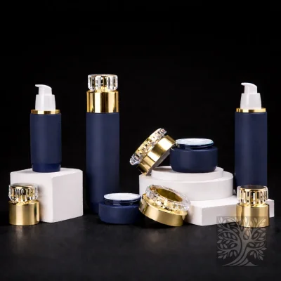 Dark blue bottles and cosmetic jars with gold caps, arranged in a balanced composition with scattered lids.