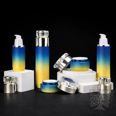 Blue to yellow gradient glass packaging set with gold accents, featuring bottles and jars on tiered platforms.