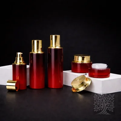 Deep red glass serum bottles and cosmetic jars with gold caps, presented in a bold coordinated product layout.