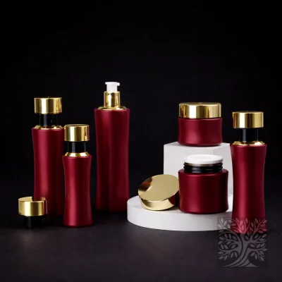 Rich red skincare bottles and matching cosmetic jars with gold caps, arranged in a bold and cohesive presentation.