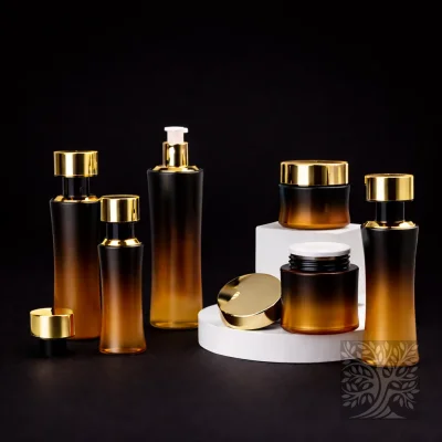 Amber gradient glass serum bottles and cosmetic jars with gold caps, arranged in a cohesive warm-toned packaging set.