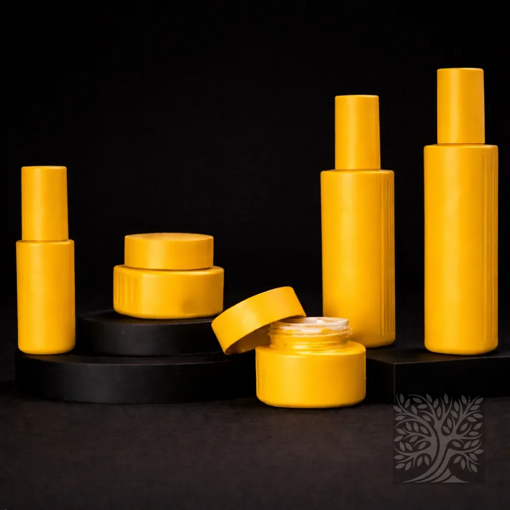 Bright yellow cosmetic bottles and jars with smooth cylindrical shapes, including a lid-off jar, displayed in a clean product lineup.