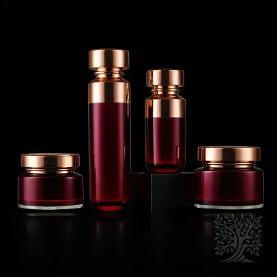 Deep red acrylic serum bottles and matching cosmetic jars with reflective gold lids, arranged in a coordinated packaging set.