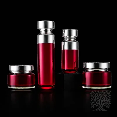 Bright red acrylic skincare bottles and matching jars with silver caps, showcasing bold color contrast in a luxury set.