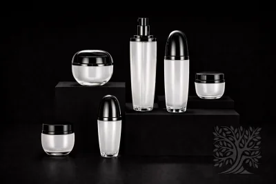 Frosted white acrylic skincare bottles and jars with black caps, arranged on black blocks with clean, minimal styling.
