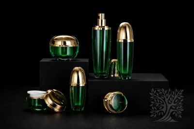 Emerald green acrylic skincare bottles and cosmetic jars with gold caps, arranged on black risers in luxe presentation.