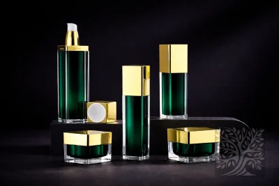 Emerald green acrylic skincare bottles with gold caps and square cosmetic jars, arranged on platforms with luxe finish.